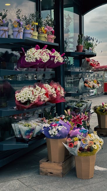 A display of various floral arrangements and bouquet gifts at flowerdeliveryfortisgreen.co.uk, featuring colorful fresh flowers including white and purple chrysanthemums, pink lilies, and mixed season